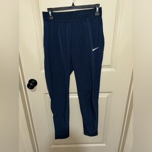 Blue Nike windbreaker pants.